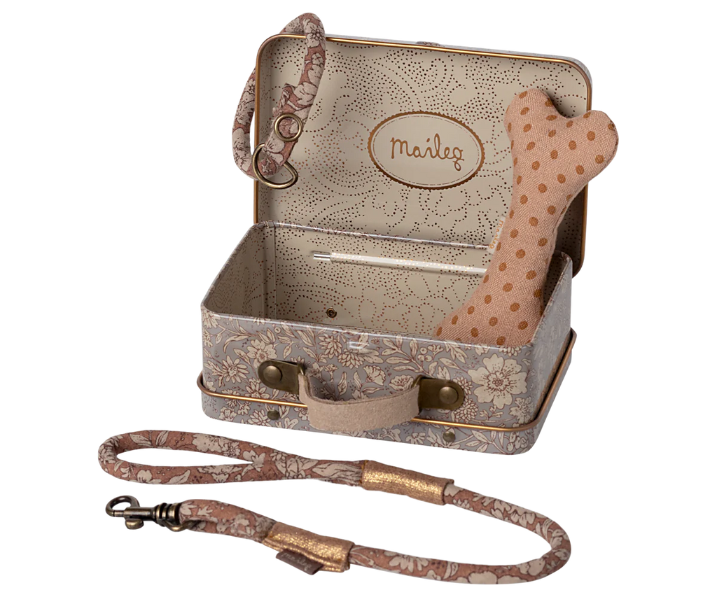 The Maileg Puppy Supply Accessories - Rose includes a small metal suitcase with a handle and “Maileg” on the lid, holding a polka-dot bone toy for your plush dog, plus a matching floral leash and collar set displayed in front.