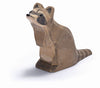 The Ostheimer Raccoon - Sitting is depicted against a white background. This handcrafted wooden toy features detailed facial markings and a striped tail, capturing the distinct characteristics of a raccoon. Its head is slightly tilted upward, and it sits on its haunches, perfect for imaginative play.