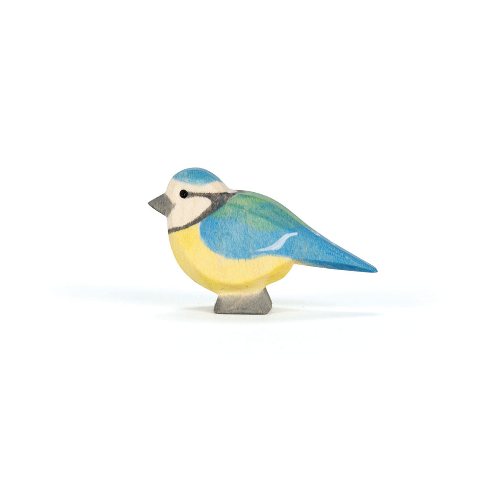 The Ostheimer Bird - Blue Tit is a small handcrafted German wooden figurine, painted in blue, green, yellow, and white hues—a charming addition to any collection.