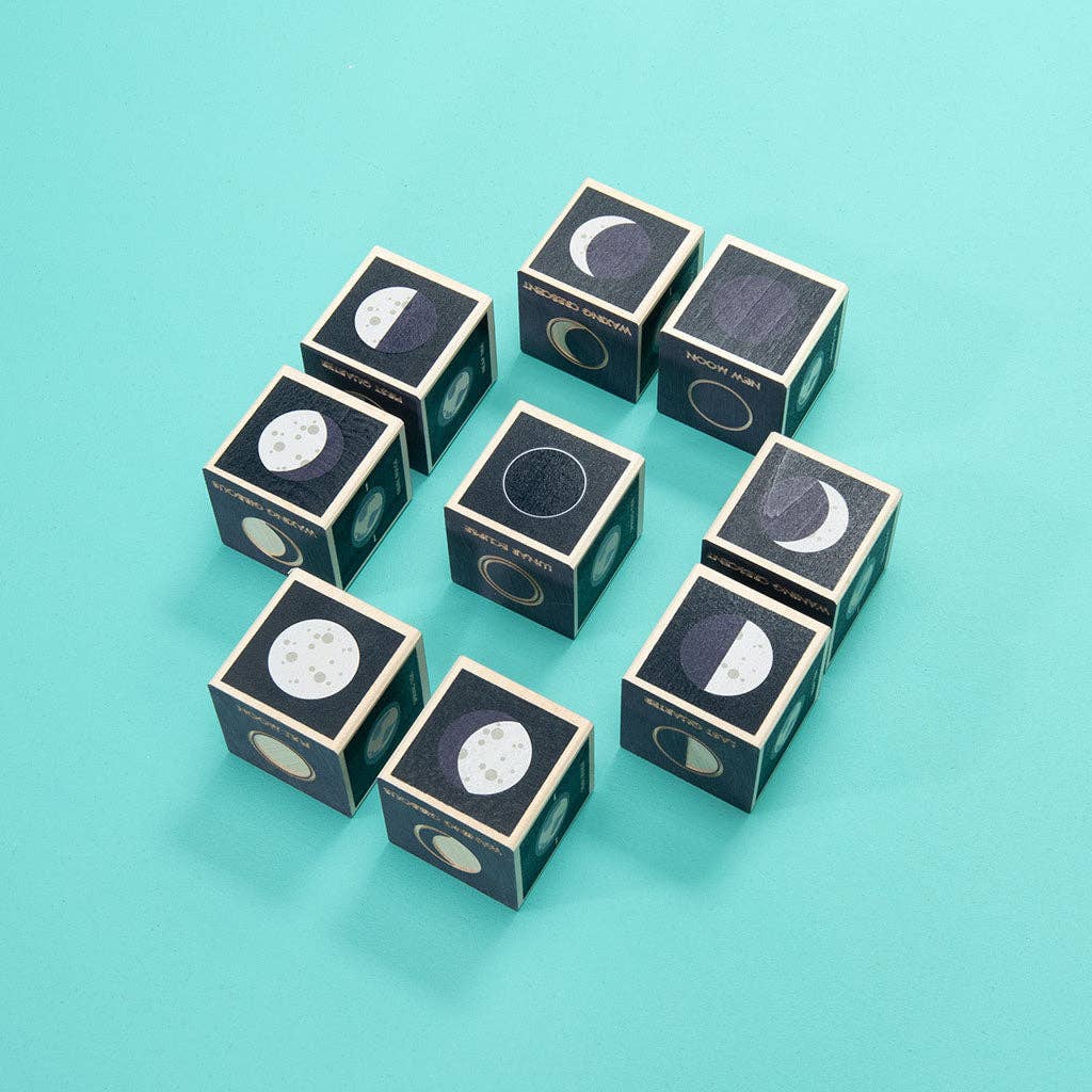 Nine Uncle Goose Moon Phase Blocks, each featuring illustrations of different lunar phases, are arranged in three staggered rows on a turquoise background.