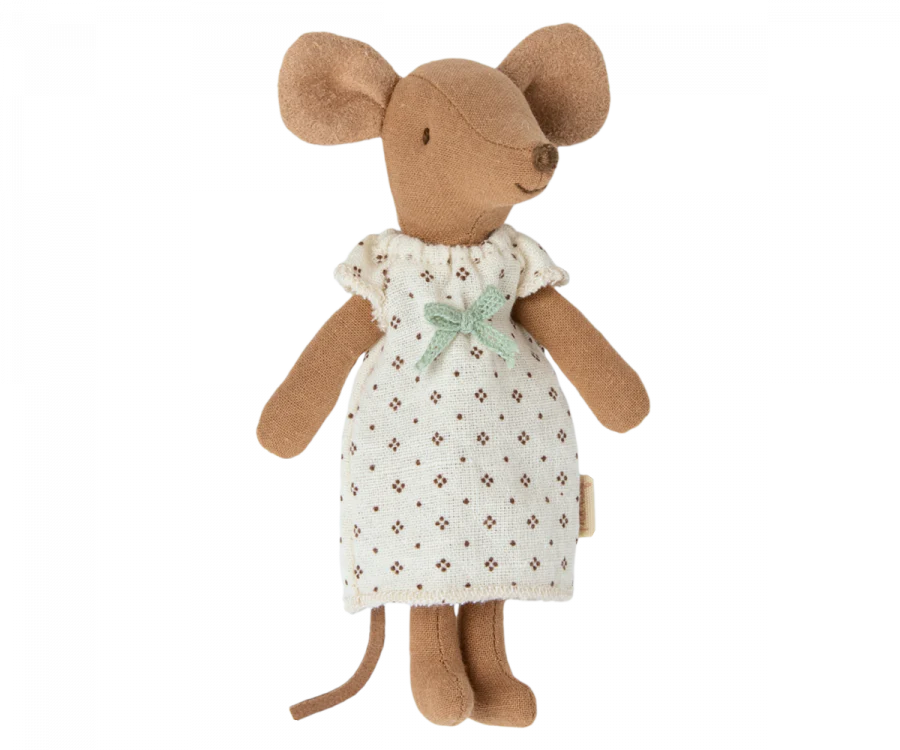 A Maileg Big Sister Mouse in Box standing, dressed in a white dress with small brown prints and a green bow at the neck, against a black background.
