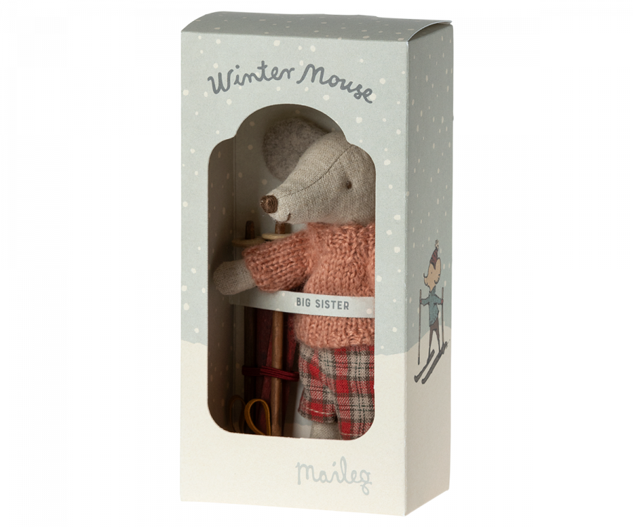 A boxed toy titled "Maileg Christmas Winter Mouse With Ski Set, Big Sister" from the brand Maileg, this enchanting winter toy features a mouse dressed in a red sweater labeled "Big Sister" and red-checkered pants. The front of the box is transparent, allowing the charming mouse and her cozy attire to be clearly visible.