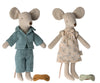 Two Maileg Mum & Dad Mice in Cigar Box toys dressed in clothing; one in a blue robe and nightwear, the other in a beige dress, standing upright with a small pillow and toy car between them.