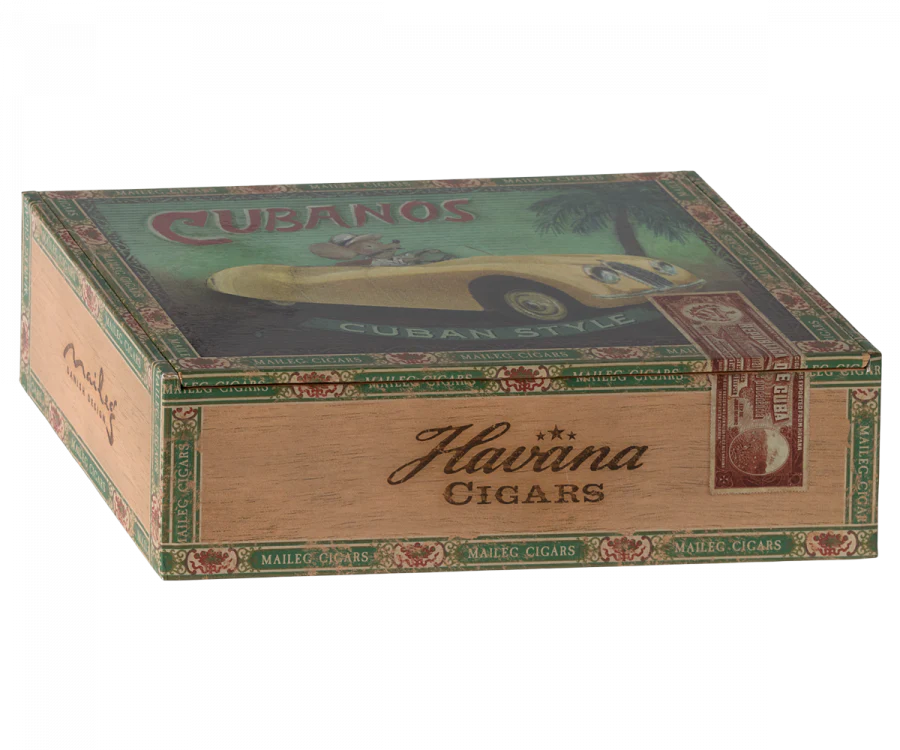A vintage wooden Maileg Grandma & Grandpa Mice in Cigarbox labeled "Havana cigars" with colorful illustrations and text advertising Cuban-style cigars. The box is slightly open, revealing its contents which include a cozy bedding arranged by grandma and grandpa mice.