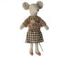 A Maileg Extra Clothing: Blouse And Skirt For Grandma Mouse toy mouse wearing grandma mouse clothes: a flower brooch-adorned patterned top, a checkered skirt, and brown shoes. The mouse has large round ears and a long tail. The fabric and design give the toy a handmade, vintage look.