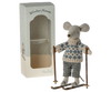 The Maileg Winter Mouse with Ski Set, Dad, features a charming dad mouse in a blue-and-white sweater and plaid pants standing on skis with poles, alongside a decorated box labeled “Winter Mouse” and “Dad.”.