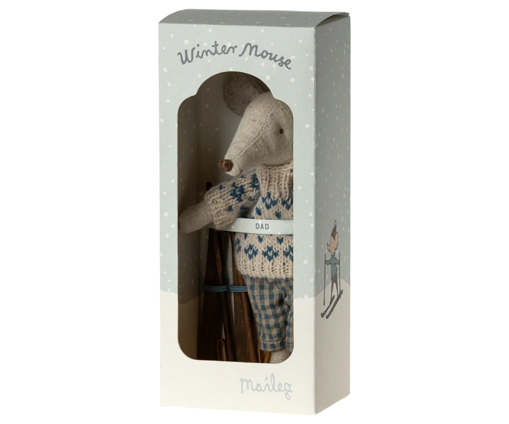 The Maileg Winter Mouse with Ski Set, Dad, is a small toy mouse in a blue and white "DAD" sweater and plaid pants, presented in a snowy "Winter Mouse" box featuring a skiing mouse illustration.