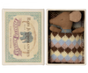 A small baby mouse with a brown body and large ears lies in a cozy, patterned sleeping bag inside a matchbox labeled "Maileg Sleepy Wakey Baby Mouse In Matchbox - Blue" by Maileg. The box is open, revealing the mouse snugly tucked in.