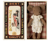 A small cloth mouse toy dressed in white clothing rests in an open matchbox. The box displays a vintage car design with "Grand Old Match Factory," "Best Quality," and "Mouse Race New Safety Matches." Contains small parts—choking hazard; not suitable for children under 3. Product: Maileg Bathroom Set.