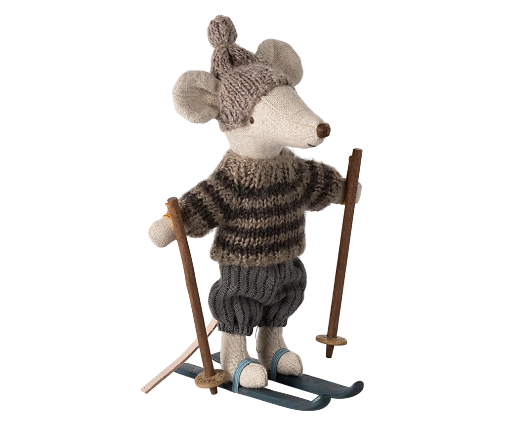 The Maileg Winter Mouse with Ski Set, Big Brother in Grey showcases a charming plush mouse toy wearing a knitted hat and striped sweater. Confidently poised on skis with ski poles, the mouse sports a cheerful expression and woolen pants, perfectly encapsulating a playful wintertime theme.