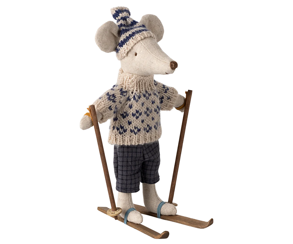 The Maileg Winter Mouse with Ski Set, Dad - Blue, is a plush toy dressed in a knitted sweater and hat, confidently clutching wooden ski poles and standing proudly on skis. This charming winter toy comes complete with ski accessories, perfectly equipped for a snowy adventure.