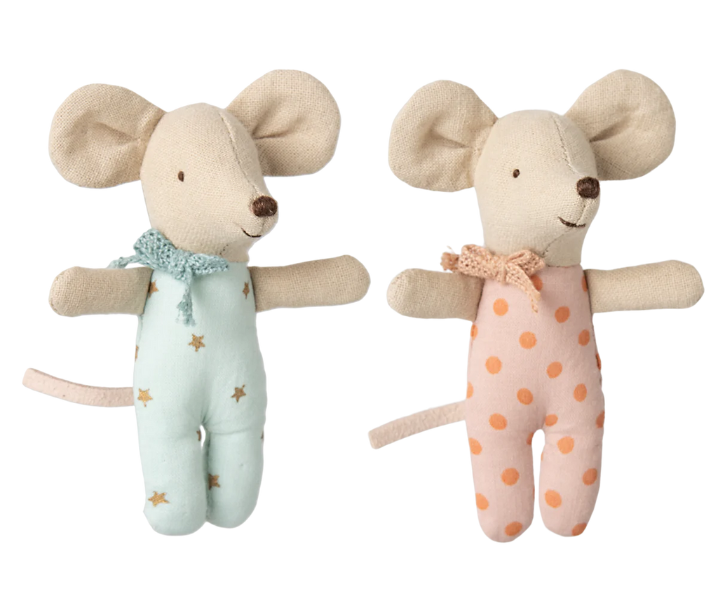 The Maileg Twin Baby Mice in Matchbox set, ready for pre-order, features two plush mice: one in a starry blue outfit with a scarf and the other in a pink polka dot ensemble with a matching scarf. Both have beige ears and tails, cheerful expressions, and fit perfectly in their cozy matchbox bed.