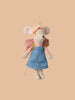 The Maileg Hiker Mouse from the Big Sister collection, dressed in a denim dress, pink plaid shirt, floral headscarf, and pink backpack, exudes adventure against a beige setting. Ideal for young explorers ready for their next hiking adventure! (Pre-order with blush sleeping bag ships in February.).