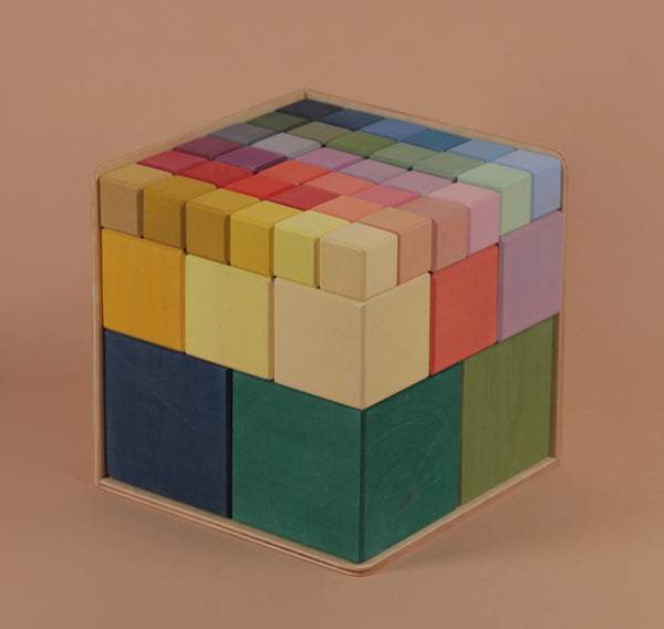 A Raduga Grez Big Cube Block Set - Colorful, composed of colorful cubes in varied colors like blue, yellow, green, and red, neatly assembled to form a larger perfect cube on a pale background.