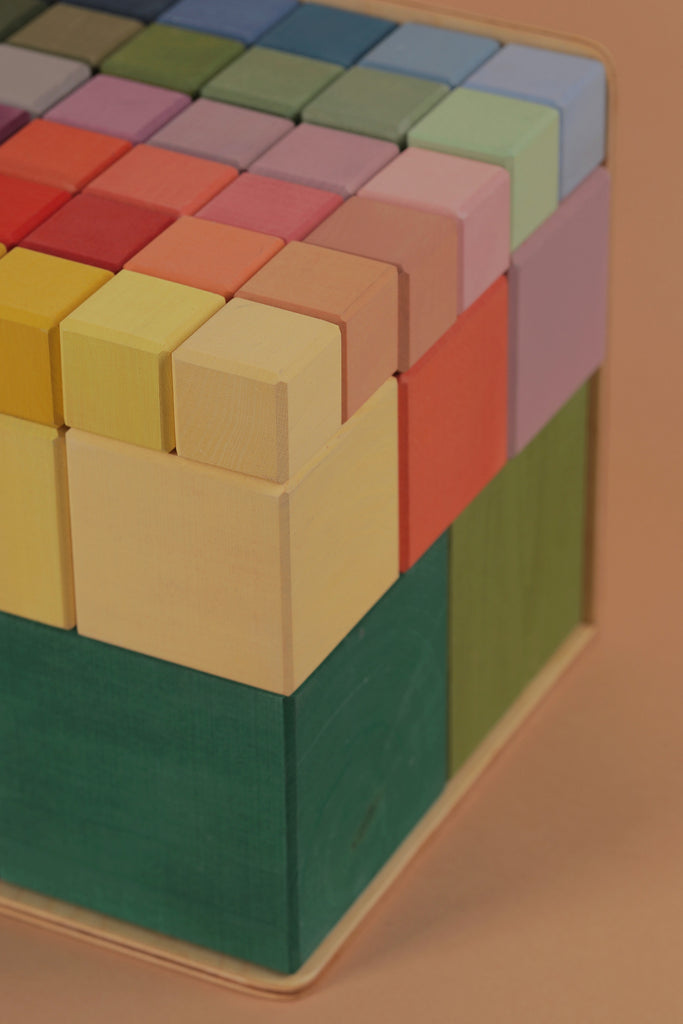 Close-up view of a Raduga Grez | Big Cube Block Set - Colorful puzzle, with pastel shades ranging from purple to green, showcasing an array of neatly aligned colorful cubes.