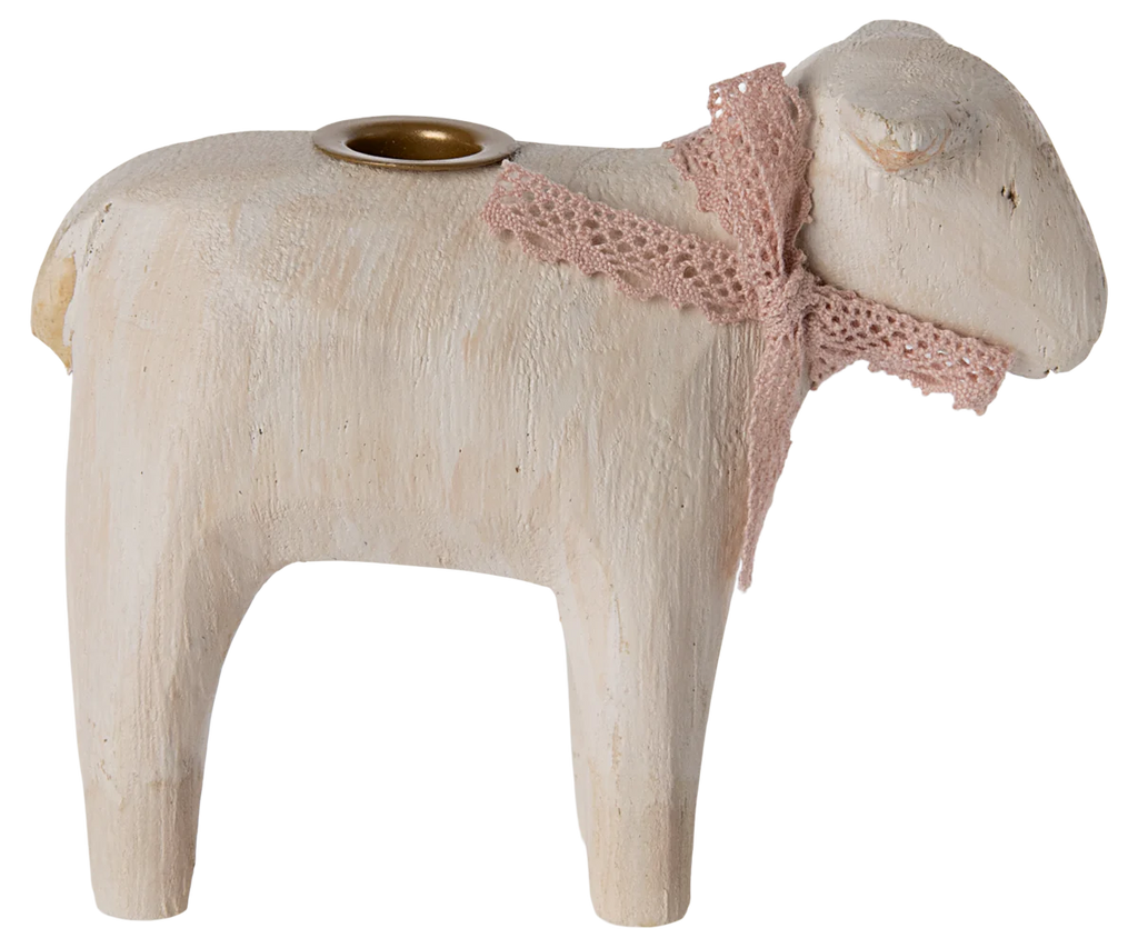 The PRE-ORDER: Maileg Wooden Candle holder - Rose Lamb, with its sheep shape and pink lace ribbon, adds charm to your Easter table. It features simple carving and a round candle holder on its back. Ships late January.