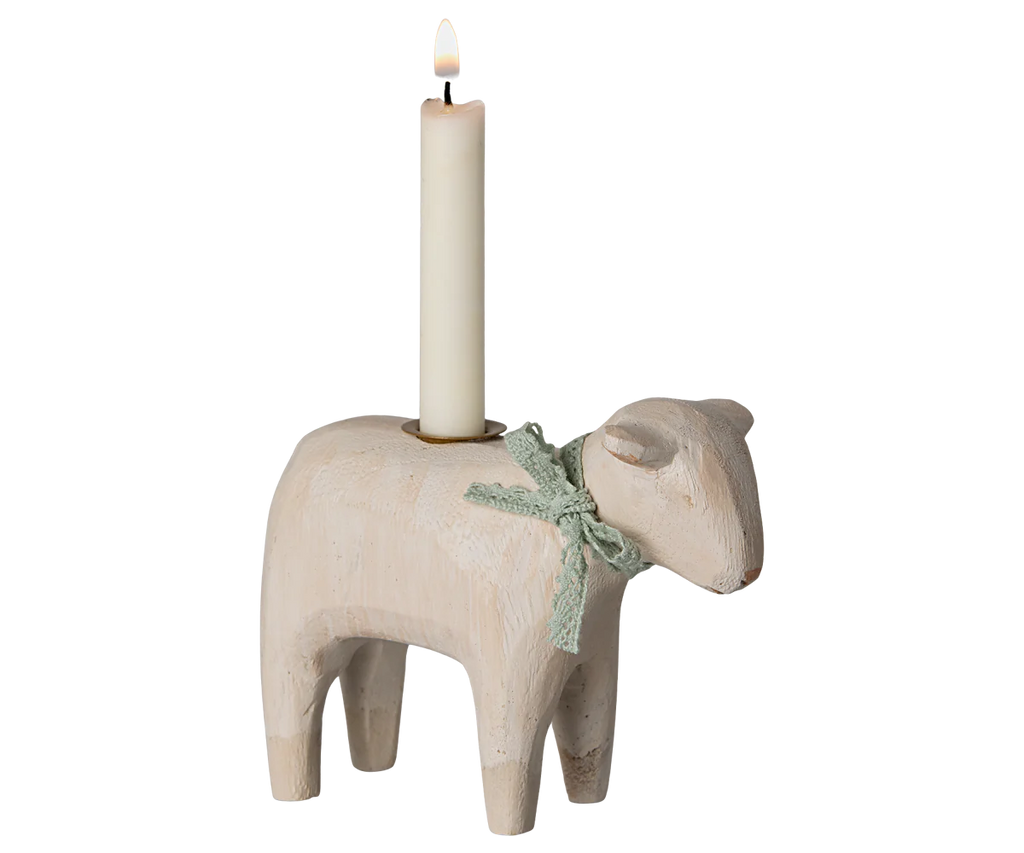 The Maileg Wooden Candle holder - Mint Lamb, available for pre-order and shipping in late January, is an enchanting sheep-shaped piece. Adorned with a green ribbon and delivering a whimsical touch, this handmade accessory is perfect as an Easter table centerpiece cradling a lit white candle.