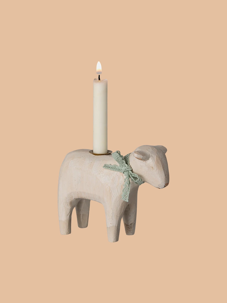 The PRE-ORDER: Maileg Wooden Candle Holder - Mint Lamb (ships late January) is a handmade wooden lamb-shaped holder with a light green ribbon and a white candle. Perfect for an Easter table setting, it stands against a solid beige background.