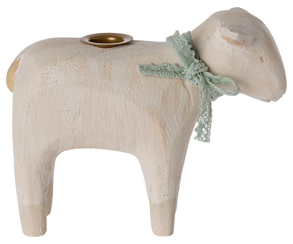 The PRE-ORDER Maileg Wooden Candle holder - Mint Lamb, shipping in late January, is a handmade wooden sheep figurine. It features a small brass-colored candleholder on its back and is adorned with a light green ribbon, bringing rustic charm to your Easter table centerpiece.