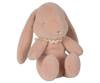 The PRE-ORDER: Maileg Easter Egg With Bunny - Powder features a soft, pink plush bunny with droopy ears and a lace collar, filled with eco-friendly recycled polyester. It is posed against a neutral background with its head gently tilted to the side. Ships in February.