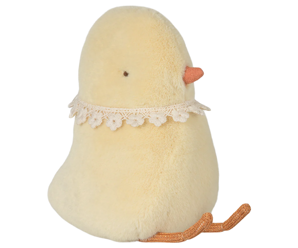 The PRE-ORDER: Maileg Easter Egg With Chick, available for February shipping, is a plush, light yellow bird toy made from recycled polyester. It has an orange beak and feet, a lace collar, and is in a sitting position, with its soft texture suitable for all ages.