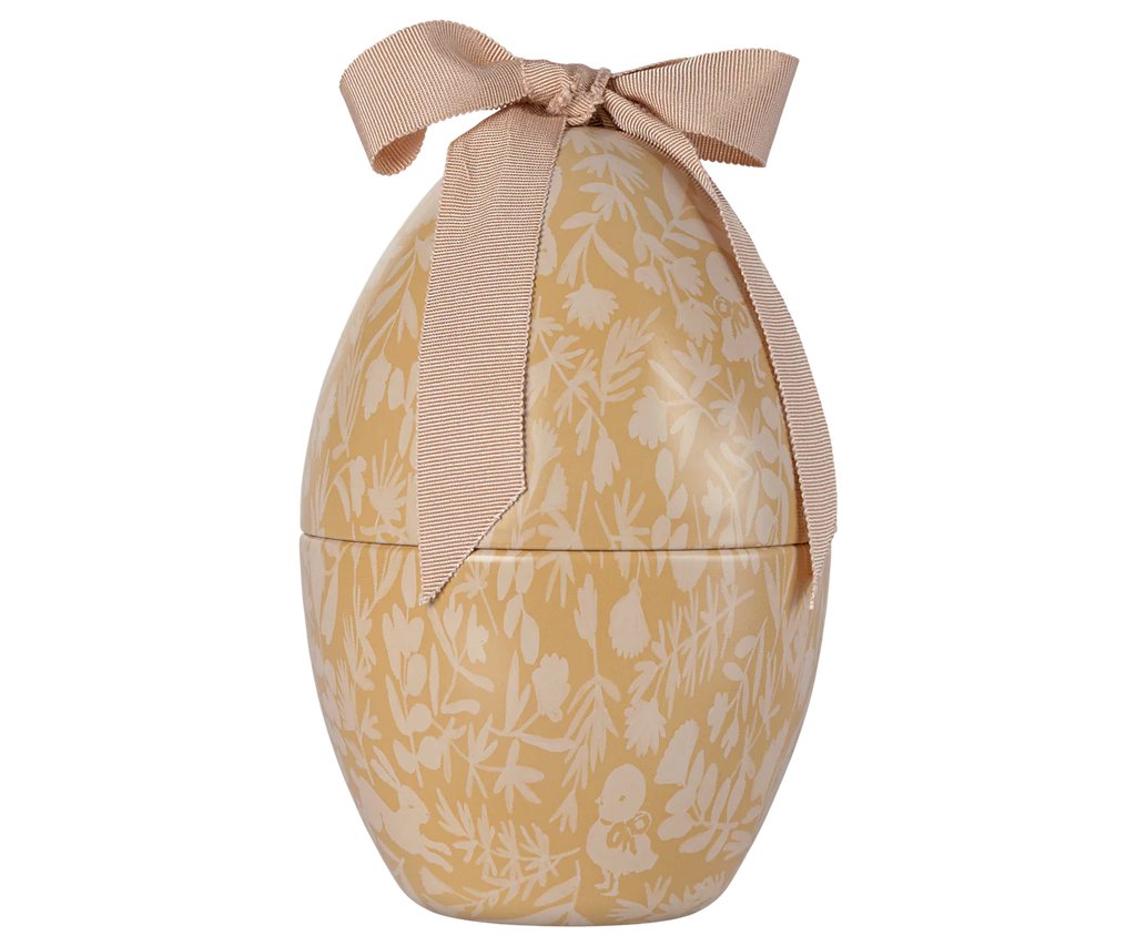 The PRE-ORDER Maileg Easter Egg in cream yellow, shipping in February, features a beautiful floral print in soft beige and white tones with a textured pink ribbon on top. This exclusive piece adds charm to your seasonal decor.