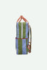 Side view of the Sticky Lemon Backpack Large | Stripes | Tickling Grass + Cloud Blue (ships in a week), a waterproof bag made from recycled PET bottles, featuring wide green and light blue vertical stripes, red accents, pinkish-orange adjustable shoulder straps, and a white zipper, shown against a plain white background.