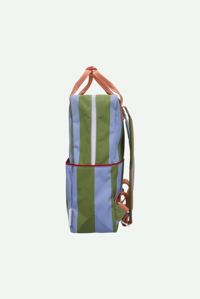 Side view of the Sticky Lemon Backpack Large | Stripes | Tickling Grass + Cloud Blue (ships in a week), a waterproof bag made from recycled PET bottles, featuring wide green and light blue vertical stripes, red accents, pinkish-orange adjustable shoulder straps, and a white zipper, shown against a plain white background.