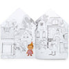 The Moulin Roty Coloring Book with Stickers – The Minouchkas features a black-and-white street scene with houses, trees, two adults walking, and a colorful Minouchkas doll in a red checked dress standing out in the foreground.
