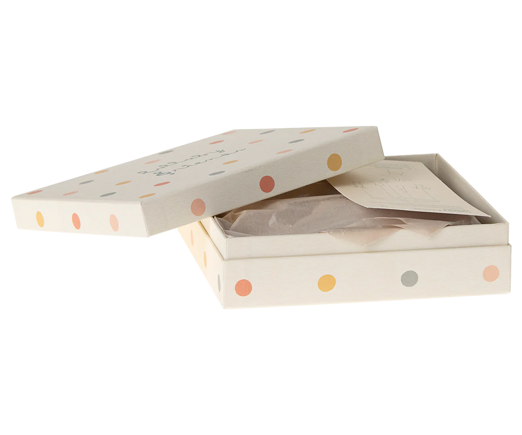 A rectangular white gift box with multicolored polka dots, partially open to reveal tissue paper, a card, and a glimpse of the Maileg Lullaby Friends Mobile with its charming printed fabrics.