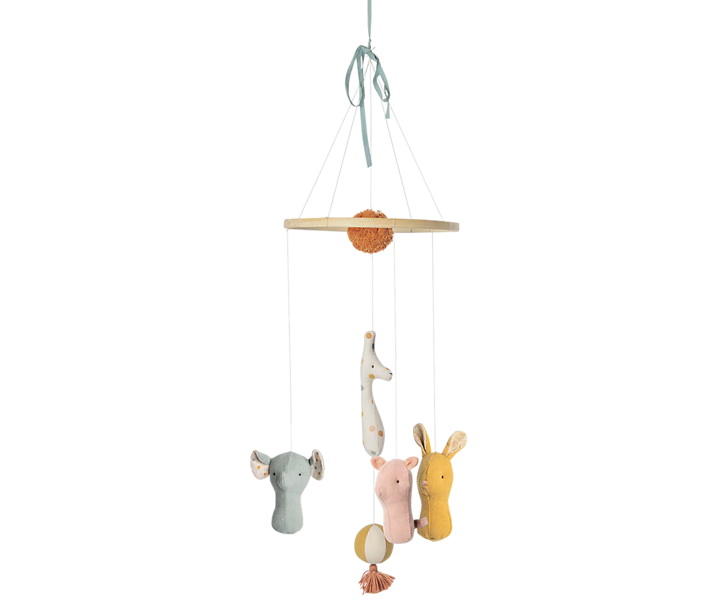 The Maileg Lullaby Friends Mobile features plush elephant, giraffe, and lion figures in pastel colors and soft fabrics, suspended from a circular wooden frame with a ribbon for hanging.