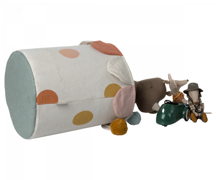 The Maileg Basket, made of white cotton linen and adorned with colorful polka dots, lies on its side, spilling out various plush toys and trinkets, including a small stuffed elephant and a toy mouse dressed in plaid.