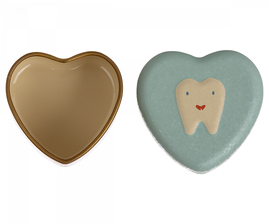 Two heart-shaped items: one is an open, empty beige container with a dark brown rim, and the other is a Maileg Tooth Box featuring a cute tooth illustration with a smiling face. The objects are side by side, evoking childhood memories, isolated on a white background.