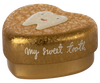 A small, heart-shaped golden box with a slightly cracked texture. The box, a perfect Maileg Tooth Box, has an illustration of a smiling tooth on the lid. The text "my sweet tooth" is written in white cursive on the side, evoking cherished childhood memories.