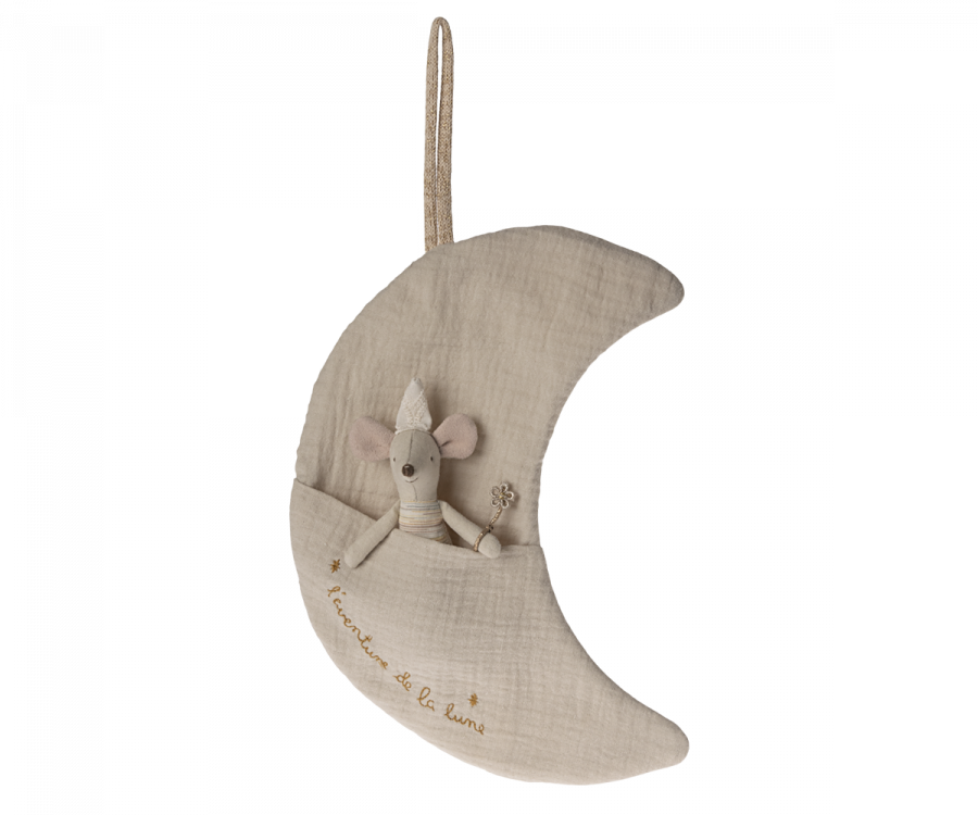 A Maileg Moon Decoration, L'aventure De La Lune, crescent-shaped and beige, features a small stuffed mouse toy nestled in a pocket on the moon. The mouse holds a tiny star wand, perfect for tooth fairy storage or as delightful children's room decor. "Friend of the moon" is embroidered in gold thread with a rope loop for hanging.