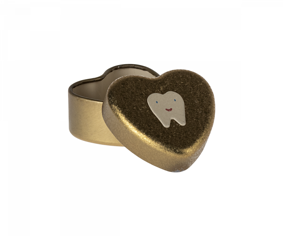 A small, heart-shaped Maileg Tooth Box with a gold exterior. The lid is slightly open, revealing the inside. The lid is decorated with an illustration of a smiling tooth, evoking childhood memories of keeping small baby teeth safe within this metal heart.