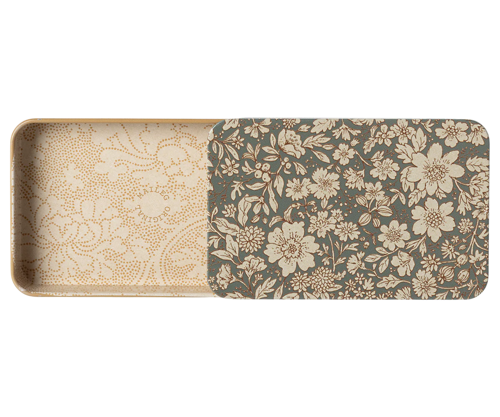 The Maileg Metal Box with Sliding Lid is a rectangular storage box adorned with an intricate floral pattern in beige and brown tones. The interior boasts a similar design with a lighter, more subtle floral motif. The lid is partially open, showcasing the inside pattern.