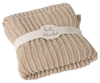 The Maileg Baby Blanket is a folded, beige knitted blanket with a cozy ribbed texture, wrapped in a cream band labeled "baby blanket" and the size.