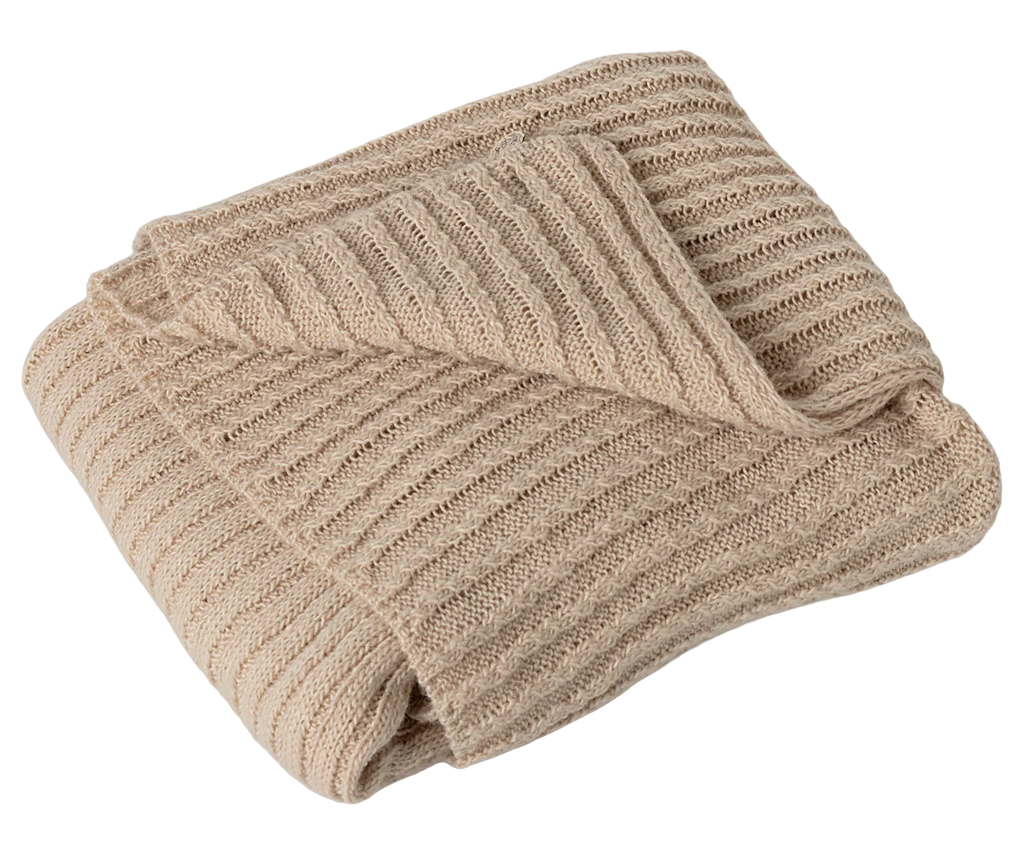 A Maileg Baby Blanket, beige and ribbed for extra coziness, is shown neatly folded against a white background.