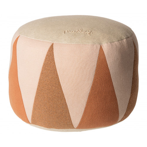 The Maileg Drum Pouf is a round fabric pouf with a beige top and sides, decorated with tan, light pink, and orange triangle patterns. Made from OekoTex cotton for softness. The word "Pouly" is embroidered on top.