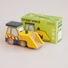 A yellow wooden toy bulldozer with black, white, and orange details—perfect for imaginative and construction play—is displayed in front of a green box labeled “No. 38 GT220 Vince | Made in England.” The box features a cartoon image of the bulldozer.