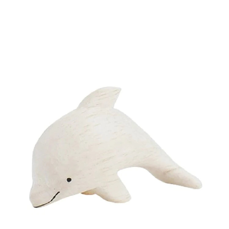 A simple handmade tiny wooden dolphin, hand-carved from eco-responsible forests, painted in light beige with visible wood grain texture, isolated on a plain white background.