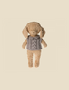 A light brown, textured plush dog toy with floppy ears is wearing a gray knitted sweater with a cable knit pattern, perfect for cold weather, set against a plain, cream-colored background.