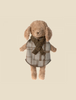 A Maileg Puppy - Knitted Scarf wearing a checkered coat and a knit scarf. The puppy has soft, light brown fur and floppy ears. The outfit, resembling something from a stylish dog wardrobe, exudes a cozy and winter-ready feel.