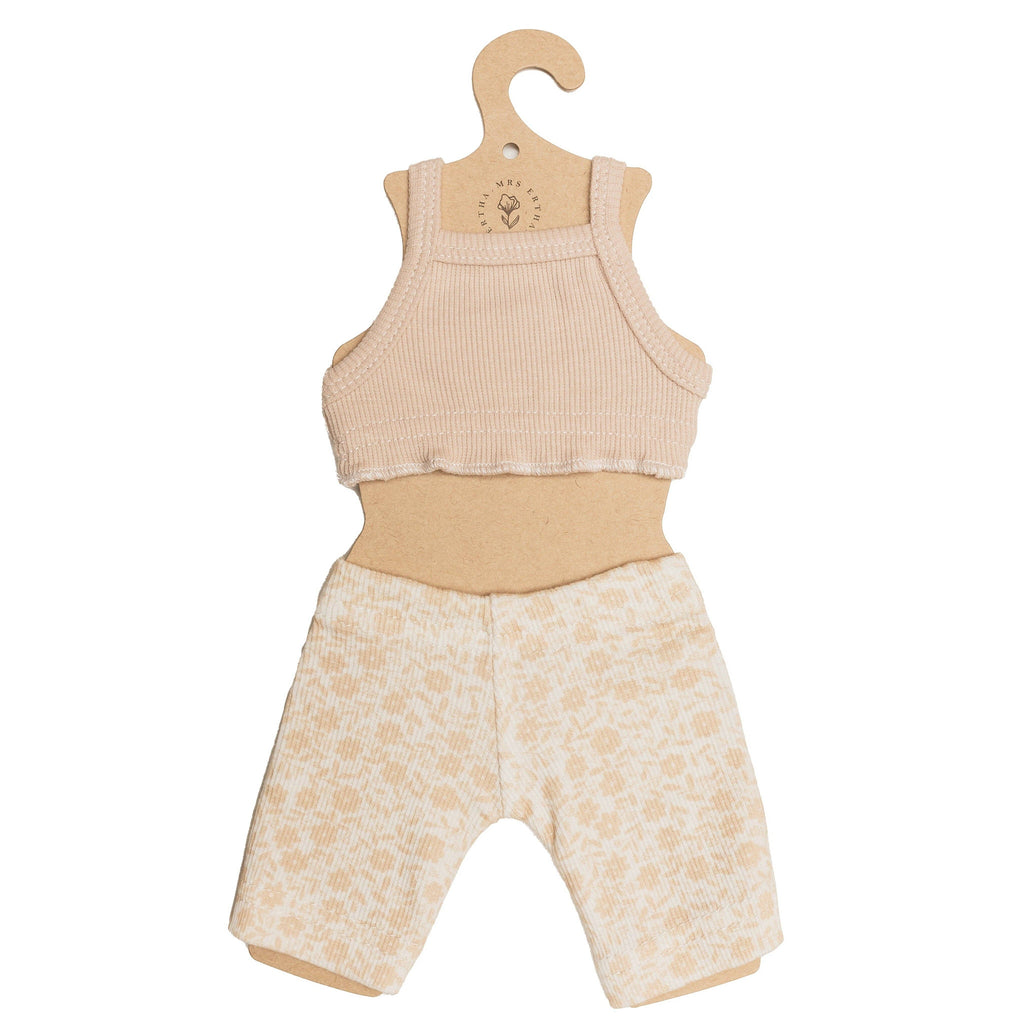 The Mrs. Ertha Doll Clothes - 13″-14″ - Bouquet Silhouette Leggings Set features a small beige tank top and patterned leggings made from organic cotton, presented on a hanger-shaped cardboard cutout—perfectly sized for Minikane dolls or other favorite toys.