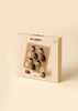 A beige box labeled “My Little Lady Bug Wooden Puzzle” contains a wooden peg puzzle featuring six numbered ladybug pieces (1–6). Designed for ages 3 and up, this Montessori-inspired counting toy encourages early number recognition and fine motor skills.