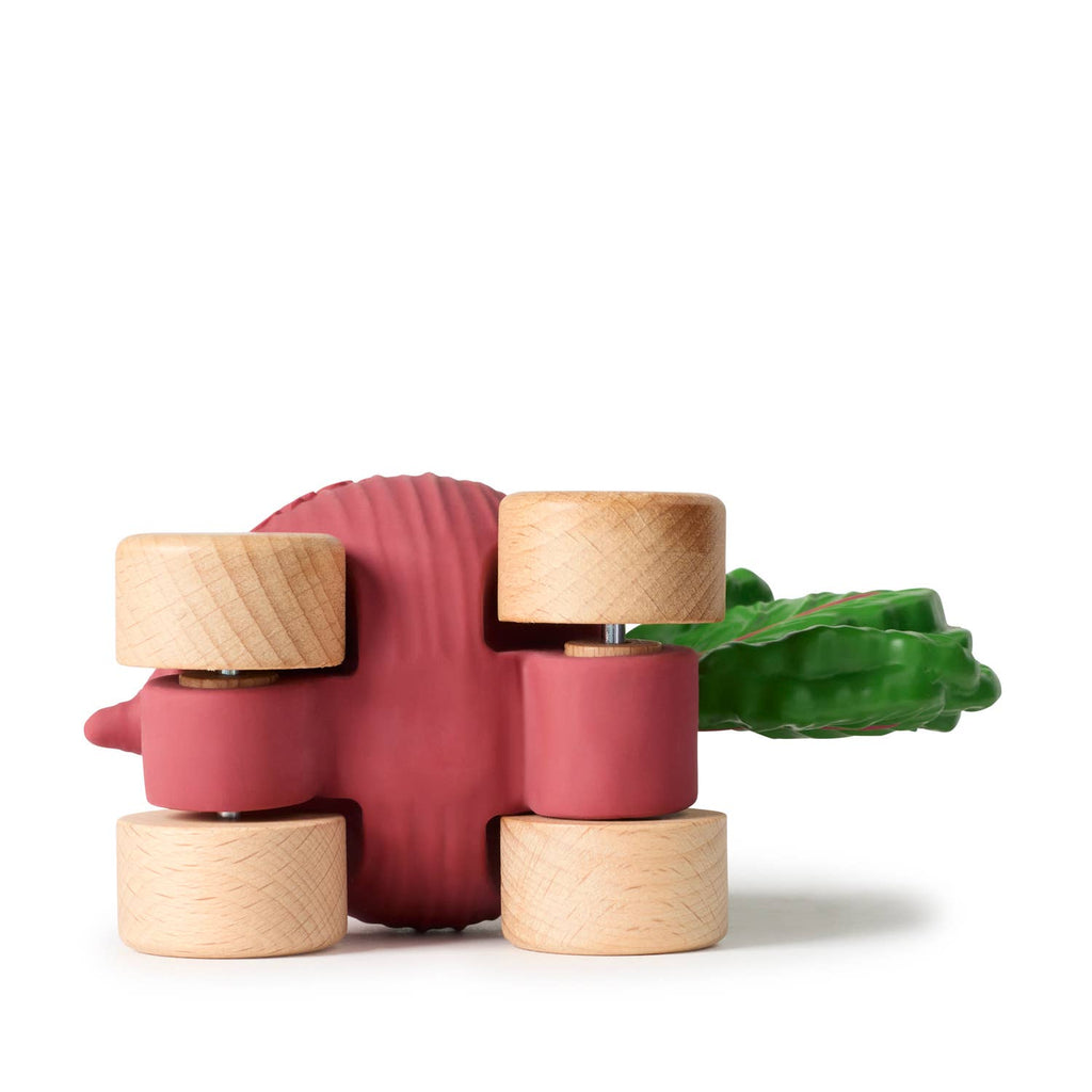 Betty The Beetroot Baby Car features a pink body, green leafy top, and four FSC-certified wooden wheels, shown from the side on a white background.