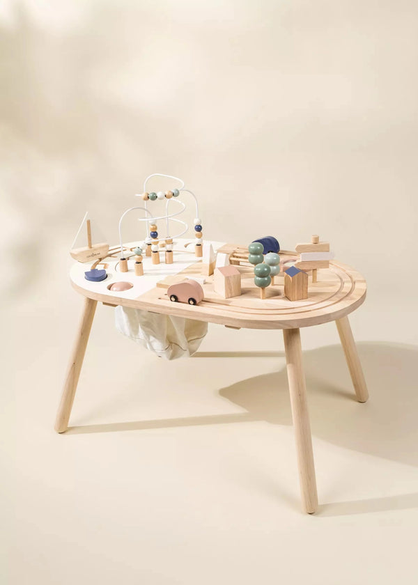 A Wooden Activity Table for children with a variety of toys including blocks, a car, and a bead maze, set on a neutral background.