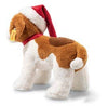 The Steiff Snuffy Puppy Dog Plush with a Santa Hat is adorned with a brown and white coat and features a festive red hat paired with a matching collar. A small tag hangs from its ear as it faces sideways to the left, making it perfect for holiday cuddles.