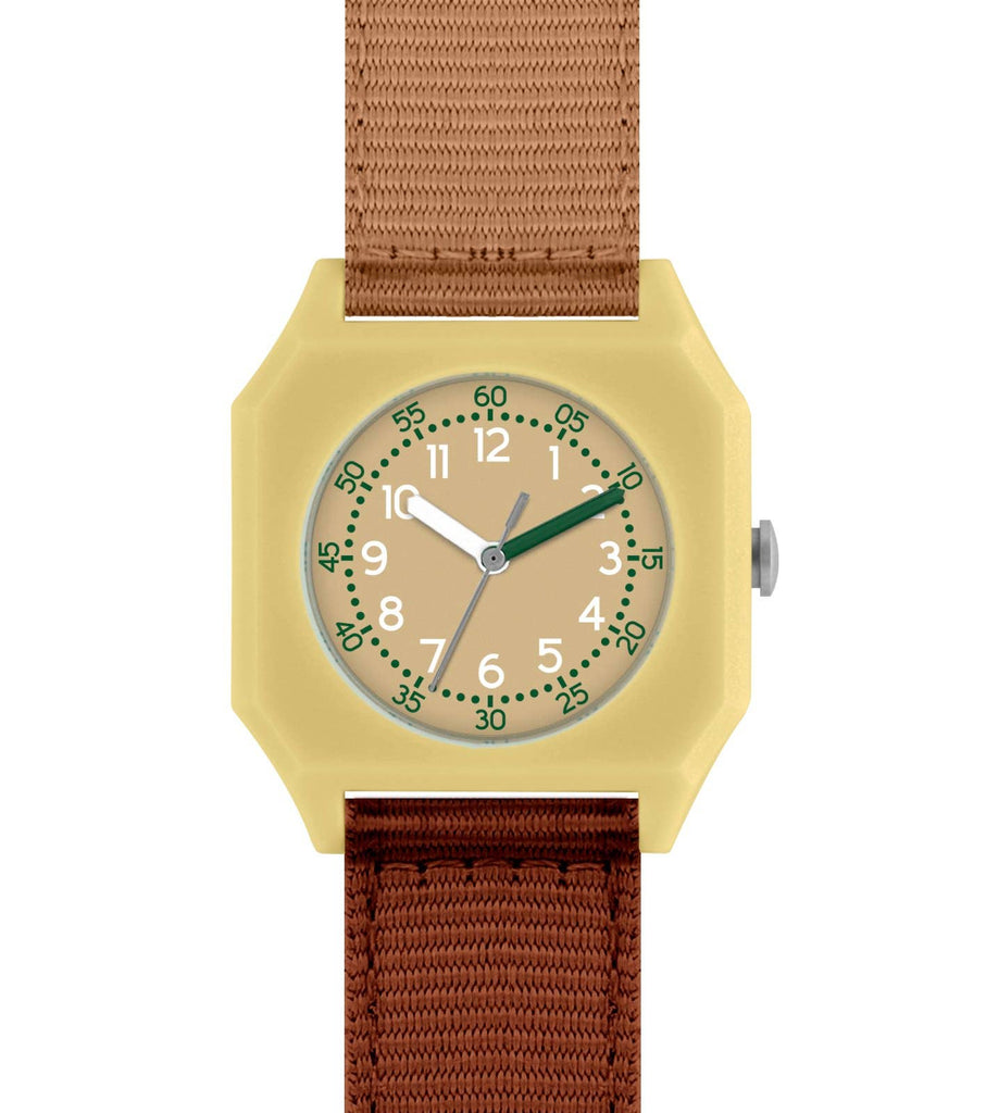 The Mini Kyomo Watch - Cherry Bomb is a square yellow kids’ watch with a beige face, green numbers and hands, and a brown fabric strap. The time shows about 1:10, with the second hand at 33 seconds—ideal for learning to tell time.